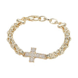 14K gold plated abstract chain bracelet with CZ stone paved cross accent and adjustable clasp closure on a white background