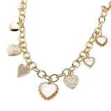 14K gold plated station necklace featuring sparkling CZ paved heart charms and mother of pearl heart accents on a chunky chain on a white background