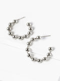 Silver beaded hoop earrings on a white background