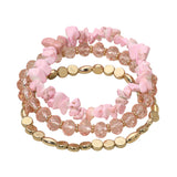 Three-piece blush pink stretch bracelet set featuring natural stone chips, faceted crystal beads, and polished gold accent beads on a white background