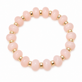 A beaded stretch bracelet featuring smooth, round pale pink beads separated by small metallic gold spacer beads, shown on a clean white background.