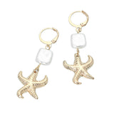 Gold coastal starfish charm drop huggie earrings with square pearl accents and lightweight beach-inspired design.