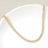 Gold emerald cut cubic zirconia tennis chain necklace on white cushion