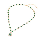 Emerald green crystal round bezel station necklace with square stone pendant gold tone on white background