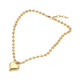 A gold ball chain necklace with a polished heart-shaped pendant, displayed on a clean white background.