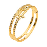 Gold stainless steel double row hinged bangle bracelet featuring sculptural interlock accents and polished finish on a white background