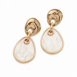 Gold geometric drop earrings featuring polished organic gold-tone studs with white marbled resin dangle accents on a white background.