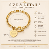 A gold heart charm chain bracelet displayed on a beige promotional card with text detailing its size, charm size, closure type, water resistance, hypoallergenic status, and stainless steel construction. The card includes the website DazzledByJewels.