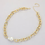 Polished gold tone chunky cable chain necklace with single baroque pearl accent full view on grey background