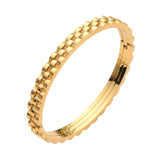 Gold stainless steel textured chain link hinged bangle bracelet featuring a dimensional chain-inspired edge and polished finish on a white background