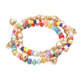 Three-piece colorful stretch bracelet set featuring multicolored beads, gold-tone heart charms, and layered stackable designs on a white background