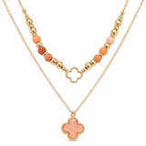 A gold-tone layered necklace set featuring a top beaded strand with peach and terracotta beads, a central openwork quatrefoil, and a longer chain with a matching peach and gold quatrefoil pendant, shown on a white background.