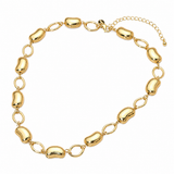 Modern metal bean link chain necklace in polished gold tone with lobster clasp and extender on white background
