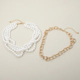2-piece multi-strand pearl and chunky gold cable chain layered necklace set flat lay on cream background