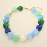 Chunky marbled ocean blue resin pebble bead statement necklace detail on cream background