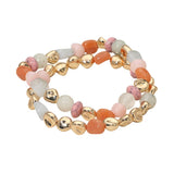 Two-piece stretch bracelet set featuring multicolor pebble-shaped beads and polished gold-tone accents in a layered design on a white background