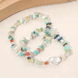 wo-piece stretch bracelet set featuring semi-precious pebble stones in soft pastel hues with an organic pearl accent on a white surface