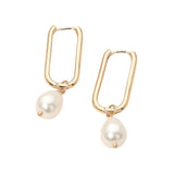 Gold geometric oval huggie hoop earrings with dangling pearl accents for elegant everyday and dressy styling.