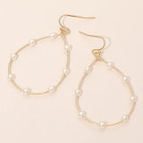 Gold pearl open hoop teardrop dangle earrings with delicate pearl accents and elegant feminine design.