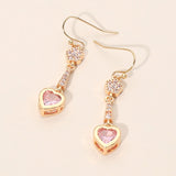 Gold pink crystal heart drop dangle earrings with sparkling pavé accents and delicate feminine design.