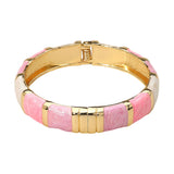 Pink and white enamel bamboo hinged bangle bracelet with gold tone accents and glossy finish on a white background