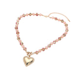 Necklace with pink beads and a heart-shaped pendant on a white background