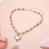 Necklace with a heart pendant on a pink background