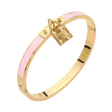 Pink enamel hinged bangle bracelet with gold-tone stainless steel finish and lock charm accent on a white background