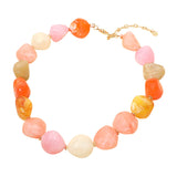 Chunky marbled resin pebble bead statement necklace in blush pink peach coral colorblock on white background