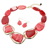 Chunky geometric red swirled acetate plate statement necklace and earring set on white background