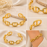 A collage showing a gold chain bracelet in multiple views: a full product view, close-up links, a detail of the clasp, and the bracelet worn on a wrist. The bracelet has a polished yellow-gold finish with elongated oval links connected by openwork oval links. Yellow gold tone SECRET BOX mariner link cuff bracelet luxury detail views