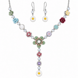A floral jewelry set featuring a silver-tone necklace and matching drop earrings. The necklace and earrings are decorated with colorful enamel flower charms in green, blue, pink, red, yellow, and purple, accented by white faux pearls and daisy charms on a silver chain.