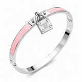 Pink enamel hinged bangle bracelet with silver-tone stainless steel finish and lock charm accent on a white background