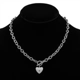 Silver chain necklace with a heart-shaped pendant on a black mannequin.