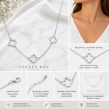Sterling silver dipped open quatrefoil link station necklace with three elegant clover charms on an adjustable chain displayed on a white background with details