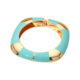 Turquoise and gold bracelet on a white background