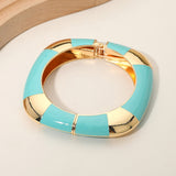 Turquoise and gold bracelet on a light background
