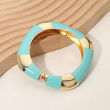Turquoise and gold bracelet on a wooden surface