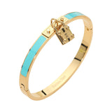 Turquoise enamel hinged bangle bracelet with gold-tone stainless steel finish and lock charm accent on a white background 