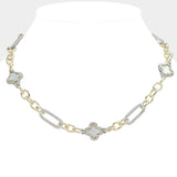 A two-tone chain necklace displayed on a white neck mannequin. The necklace features alternating gold and silver-tone links, with silver-tone four-leaf clover motifs inlaid with white mother-of-pearl.