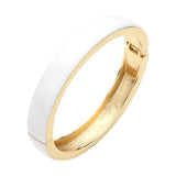 White enamel hinged bangle bracelet with gold tone finish and sleek minimalist design on a white background